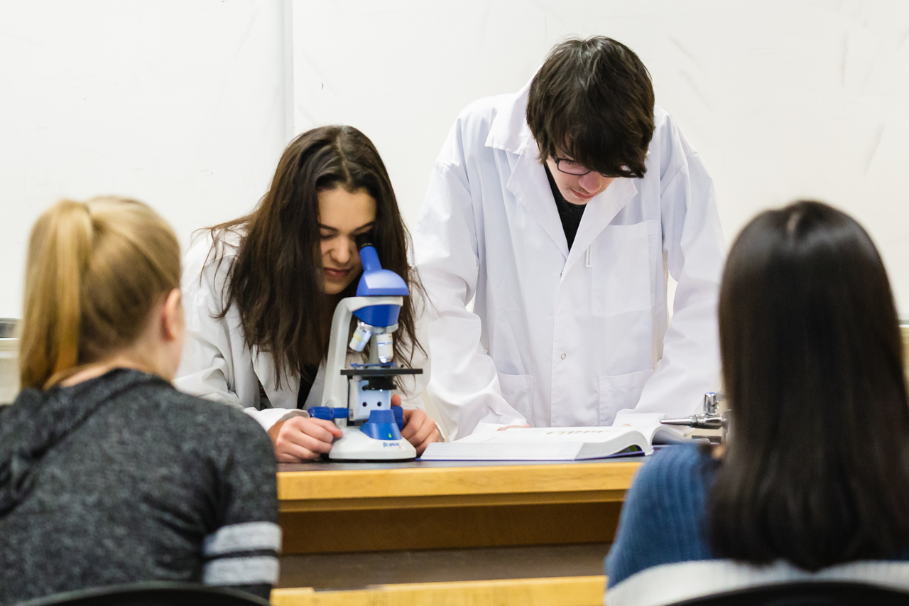 students-looking-into-microscope-in-class