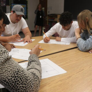 four-students-at-a-table-doing-school-work