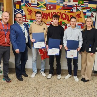 group-of-three-international-students-holding-certificates-at-hammarksjold-with-three-teachers