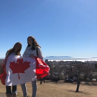 international-students-holding-canada-flag-in-front-of-sleeping-giant-at-hillcrest