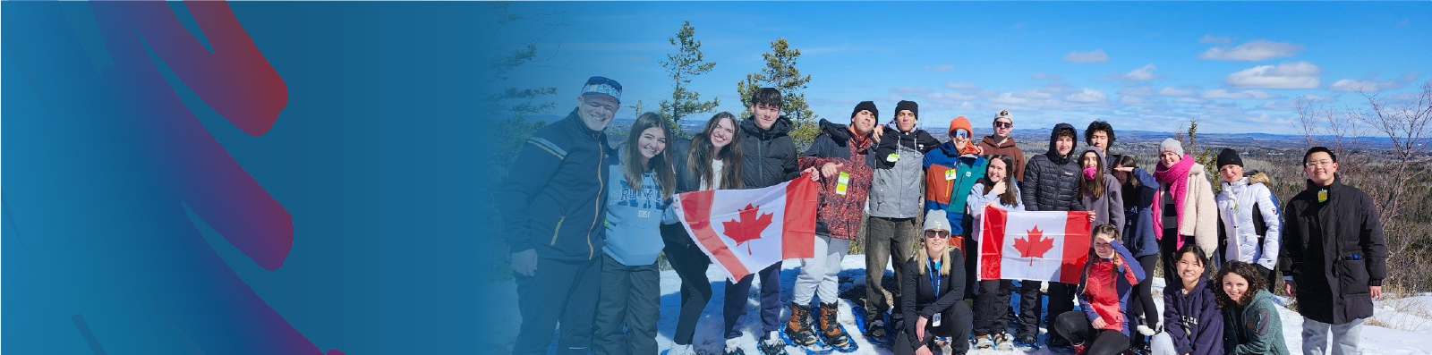 hero-image-of-international-students-snowshoeing-on-hill-holding-canada-flag