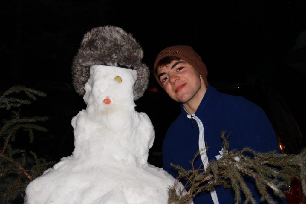 international-student-rodrigo-marcilla-molina-beside-a-snowman
