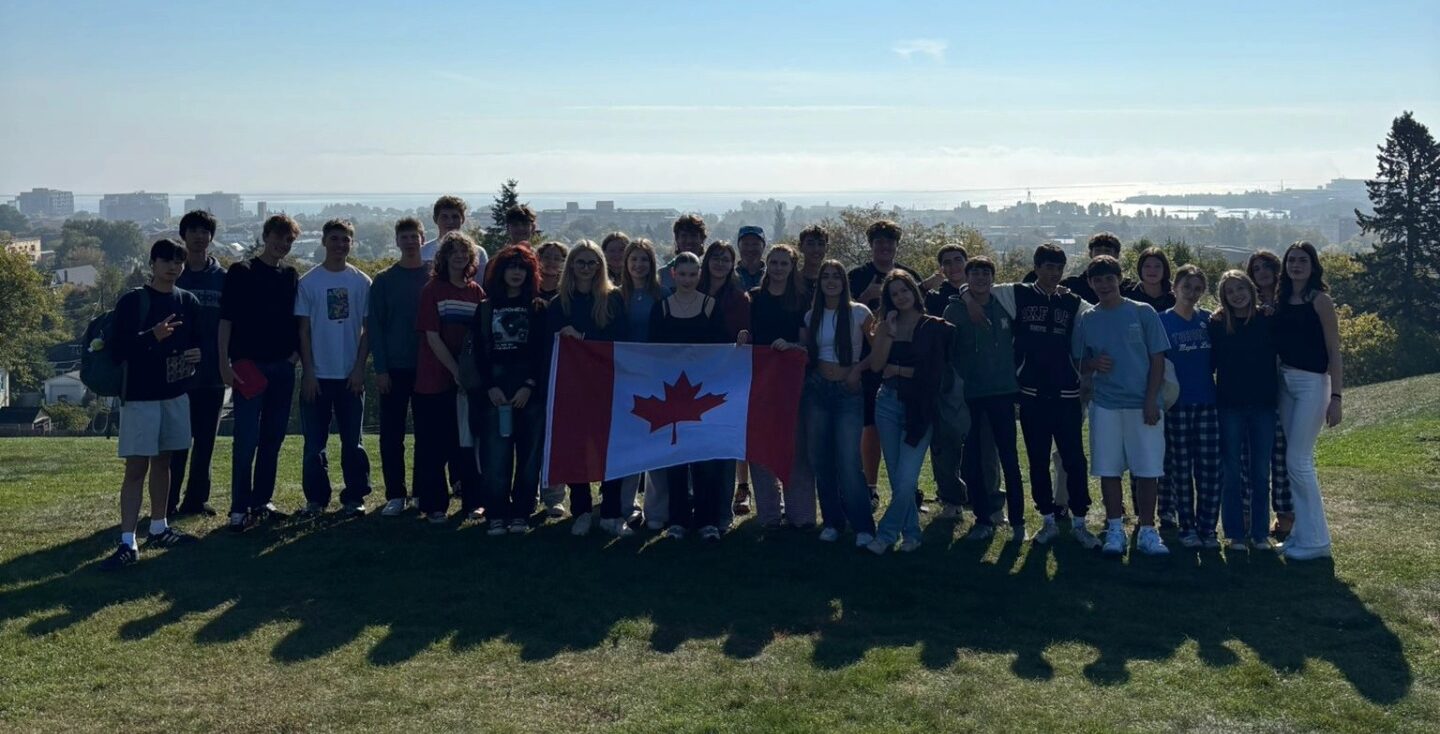 cropped-group-of-international-students-at-hillcrest-holding-canada-flag-with-city-and-lake-superior-in-background