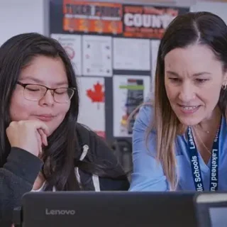student-and-teacher-looking-at-a-computer-together